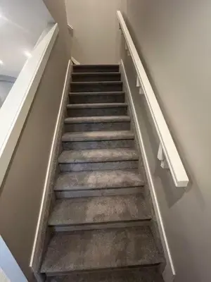 a stairway in a building with a stair case at Brand New Bedroom with private bathroom in Keswick in Edmonton