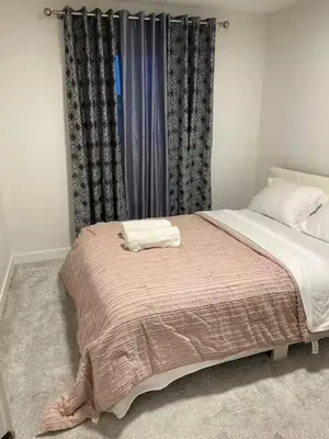 a bedroom with a bed with a blanket on it at Bedroom in Upland A in Edmonton