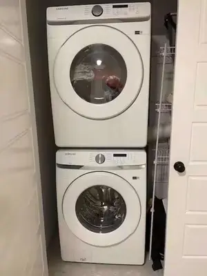a washing machine and a dryer in a room at Bedroom in Upland A in Edmonton
