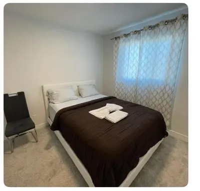 a bedroom with a bed with two towels on it at Bedroom in Upland B in Edmonton