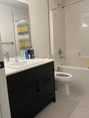 a white bathroom with a sink and a toilet at Bedroom in Upland B in Edmonton