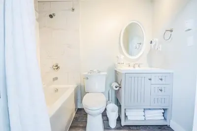 a bathroom with a toilet and a sink and a mirror at Alpenglow Lodge by Elevate Vacations in Whistler