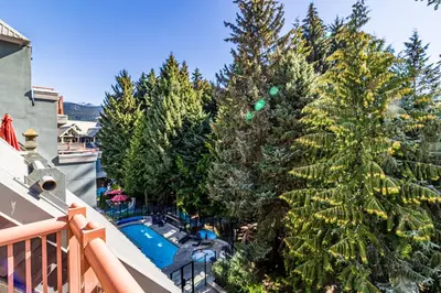 a balcony with trees and a swimming pool at Alpenglow Lodge by Elevate Vacations in Whistler