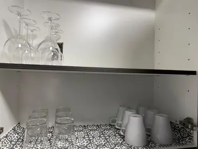 a bunch of glasses are lined up on a table at THE GUEST HOUSE WEST EDMONTON Mall in Edmonton