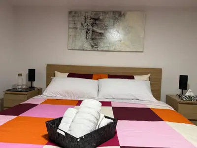 a bedroom with a bed with a colorful blanket at THE GUEST HOUSE WEST EDMONTON Mall in Edmonton