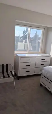 a bedroom with a white dresser and a window at Happy Zone Suite - Sleeps 4, Free Treats ! in Langford