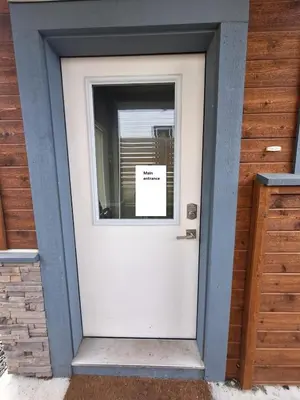 a white door with a sign on the window at Happy Zone Suite - Sleeps 4, Free Treats ! in Langford