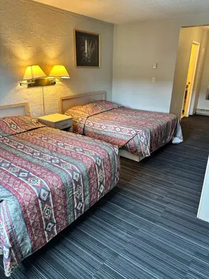 a hotel room with two beds and two lamps at Fortunes Landing Motor Inn in Enderby