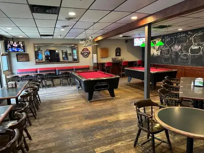 a restaurant with a pool table and ping pong tables at Fortunes Landing Motor Inn in Enderby
