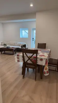 a room with a table and a bench and a bed at Basement suite -Langley Willoughby in Langley