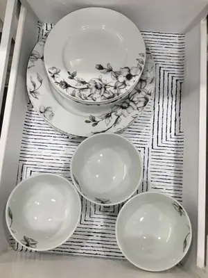 four plates and a bowl sitting on a shelf at Almost Heaven - Cozy 2BDRM APT near Heritage Park,Spruce Meadows & Banff-SW Calgary in Calgary