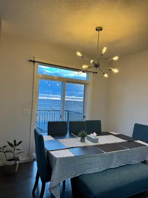 a dining room table with a view of the ocean at Exquisite Entire 4- Bed rooms vacation home! in Calgary