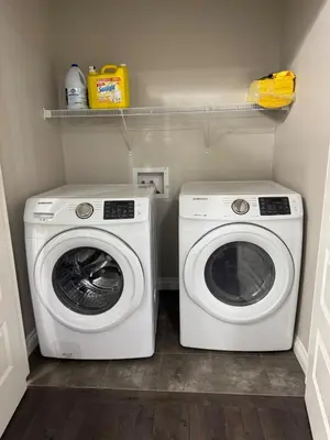 a laundry room with a washer and a dryer at Exquisite Entire 4- Bed rooms vacation home! in Calgary