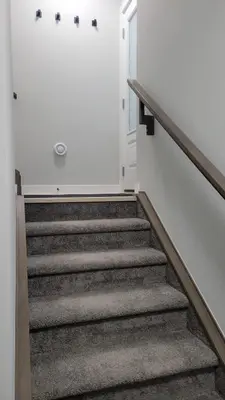 a stairway leading to a door in a house at Cozy 1 bedroom basement suite in Southwest Calgary in Calgary
