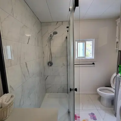 a bathroom with a shower and a toilet at Sea view stay in Lantzville