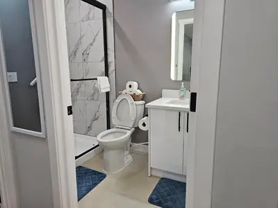 a bathroom with a toilet and a sink at Lovely Brand New 2 Bedroom Suite in Calgary in Calgary