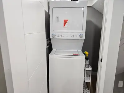a washer and dryer in a small room at Lovely Brand New 2 Bedroom Suite in Calgary in Calgary