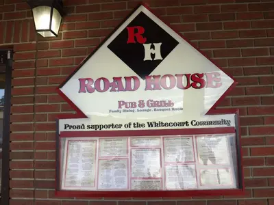 a road house sign on the side of a brick building at Canadas Best Value Inn Whitecourt in Whitecourt