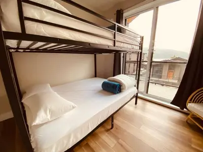 a bedroom with two bunk beds and a window at Haven On The Hill in Port Renfrew