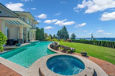 a swimming pool in the backyard of a house at Spectacular, Water View House! Property overview! in West Vancouver