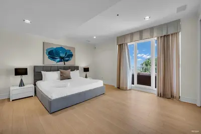 a bedroom with a bed and a large window at Spectacular, Water View House! Property overview! in West Vancouver