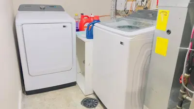 a white washer and dryer next to a washing machine at Calgary Airport Stay Private Suite 1Bed in Calgary