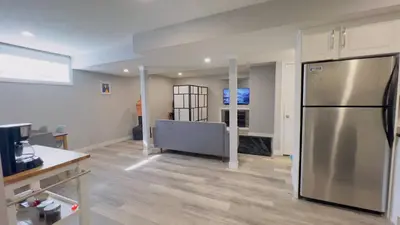 a kitchen with a stainless steel refrigerator in a room at Calgary Airport Stay Private Suite 1Bed in Calgary
