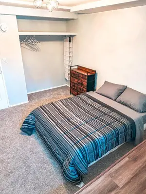 a bedroom with a large bed and a closet at Modern Downtown Stay in Yellowknife