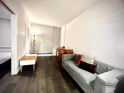 a living room with a couch and a large window at Fashion 1B1B locates in the heart of Richmond in Richmond