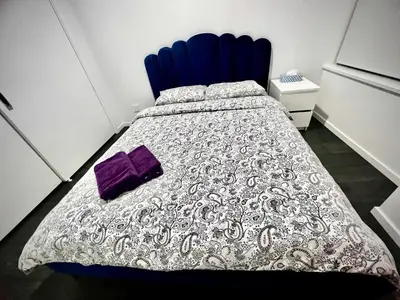 a bedroom with a bed with a purple pillow on it at Stylish 1B1B locates in the heart of Richmond in Richmond