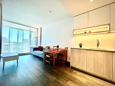 a kitchen and living room with a table and a couch at Stylish 1B1B locates in the heart of Richmond in Richmond