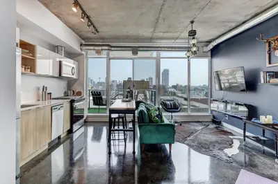 a kitchen with blue walls and a large window at Boutique Studio City Views, Patio, Fireplace Voglio Bene in Calgary