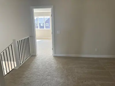 an empty room with white walls and a hallway with a door at Full AC Brand New House with 3 Bedroom in Airdrie