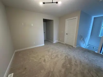 an empty room with blue walls and a white door at Full AC Brand New House with 3 Bedroom in Airdrie