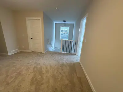 an empty living room with a door and a hallway at Full AC Brand New House with 3 Bedroom in Airdrie