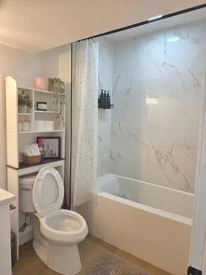 a bathroom with a toilet and a shower and a tub at Amaville- The Cozy Cave - Minutes to WEM & YEG in Edmonton