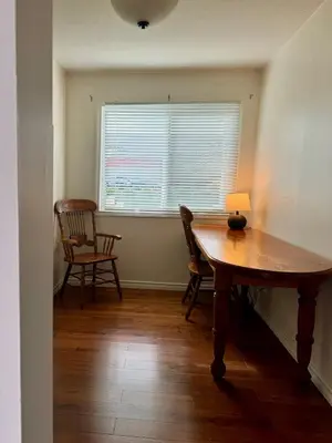 a dining room with a table and chairs and a window at Blue Cypress Suite- Downtown Tofino in Tofino