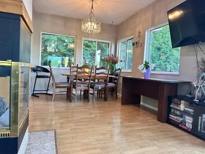 a kitchen and dining room with a table and chairs at Golden Ears Serenity in Maple Ridge District Municipality