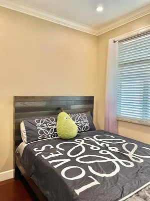a bedroom with a bed with a pillow on it at Central & Comfy 1B1B in Vancouver