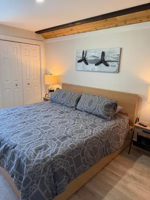 a bedroom with a bed and two white doors at Beach Bed and Breakfast in Grand Forks
