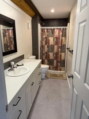 a bathroom with a sink and a toilet and a shower at Beach Bed and Breakfast in Grand Forks