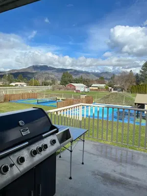 a grill and a table next to a swimming pool at Beach Bed and Breakfast in Grand Forks