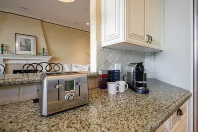 a kitchen with a counter top with a stove top oven at Luxury 5BR Villa, Gym, Theater & Ocean Views in West Vancouver