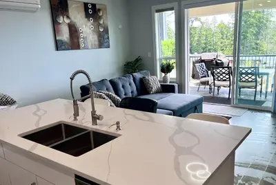 a kitchen with a sink and a living room at Winter Deal! Stunning Ocean View Modern 1 BDR Private Entry Suite in Colwood
