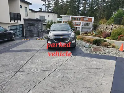 a car parked in a driveway with a parked vehicle sign at Winter Deal! Stunning Ocean View Modern 1 BDR Private Entry Suite in Colwood