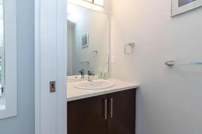 a bathroom with a sink and a mirror at Come On In, The Water View Is Waiting For You,,, in Oak Bay