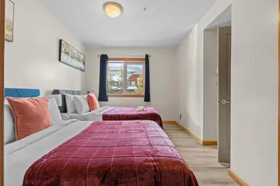 a bedroom with a large bed and a couch at Heated Outdoor Pool & Tubs 9 Guests in Canmore