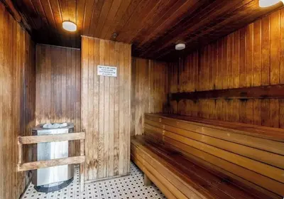 a sauna with wooden benches and a trash can at Lucy's House in Vancouver