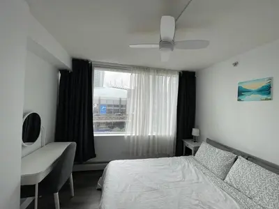 a bedroom with a bed and a window at Lucy's House in Vancouver