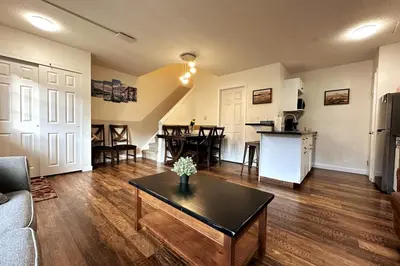 a living room with a couch and a table at Banff Boundary Lodge Mountain View 2Brms 3xAC Townhouse in Canmore